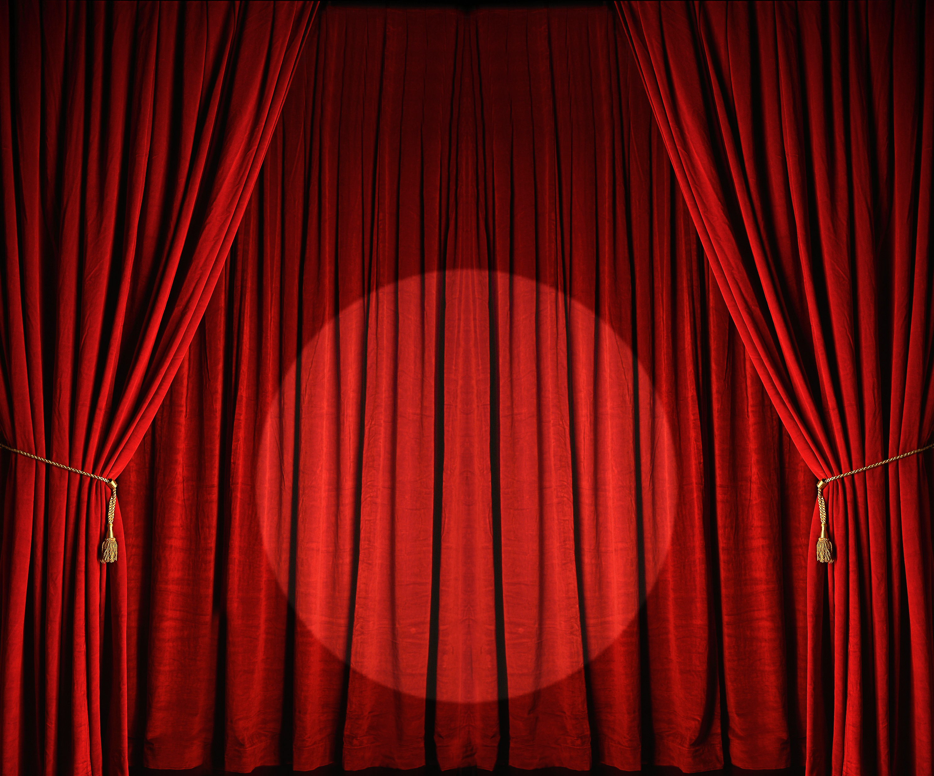 Large red theatre curtains with spotlight